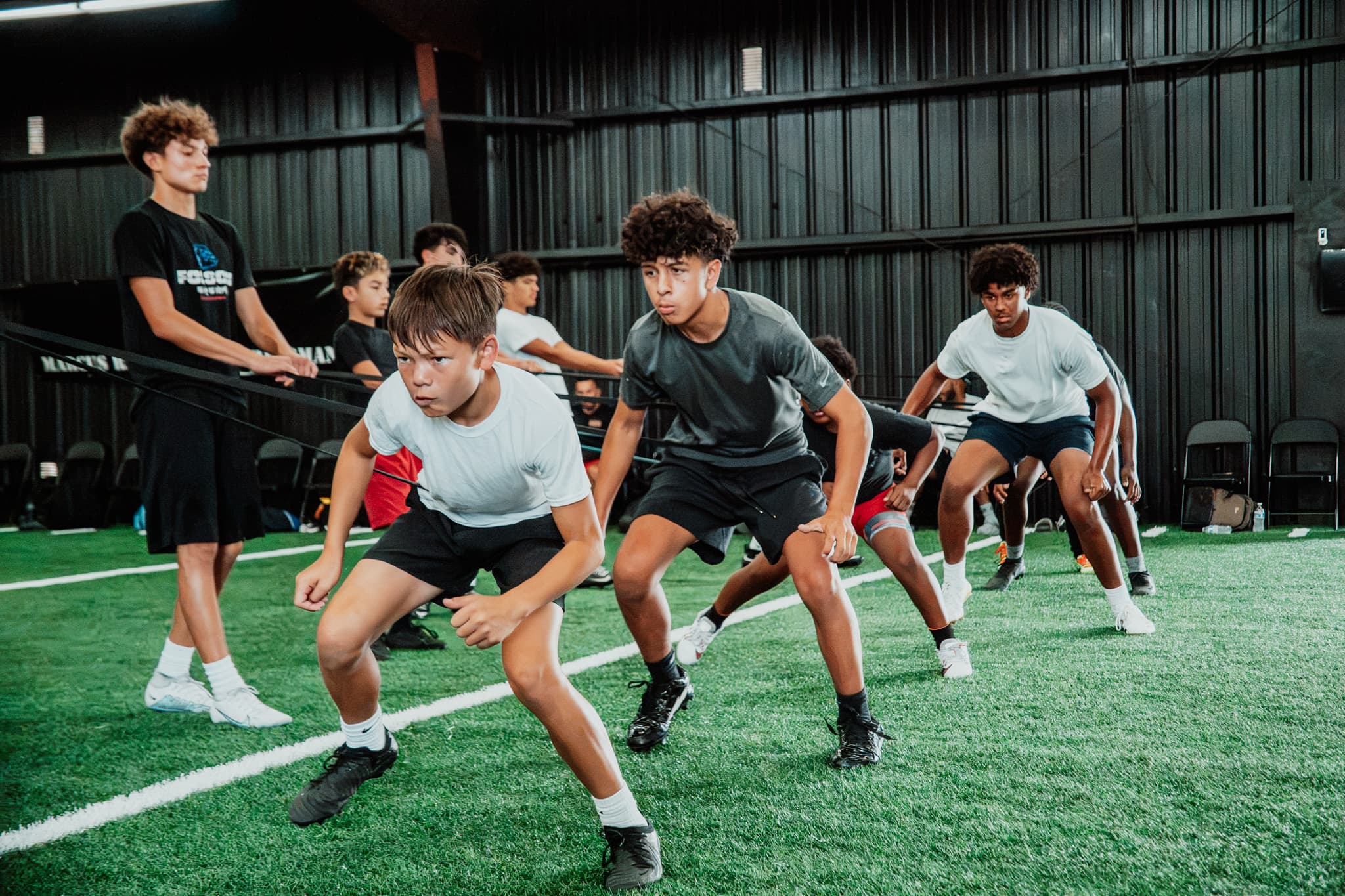 Student-athletes running an agility drill